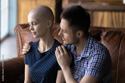 Serious concerned husband consoling cancer wife. Man giving love, comfort, support, empathy to tired frustrated hairless young girlfriend with oncology disease, hugging, touching shoulders