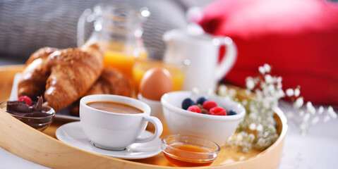 Wall Mural - A tray with breakfast on a bed in a hotel room