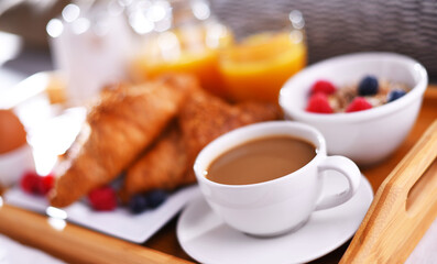 Wall Mural - A tray with breakfast on a bed in a hotel room