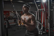 © Georgii - Muscular athletic african american man training in gym. Bodybuilding sport, strength workout