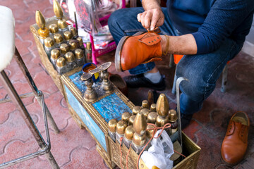 Professional shoe shine in Turkey. The process of working of shoe shine on the street of Antalya.