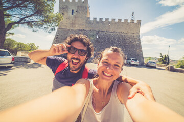 Wall Mural - happy tourists couple taking selfie photo with panorama of Campobasso in Molise region, Italy