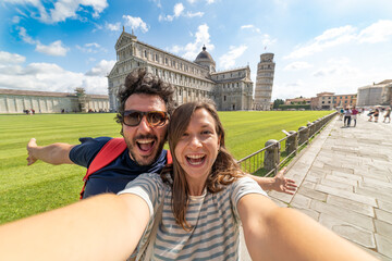 Wall Mural - Travel tourists friends taking photo selfi with smartphone in Pisa, Tuscany. happy couple in love traveling in Europe having fun taking self-portrait picture in Pisa by Leaning Tower of Pisa, Italy.