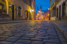 Poland, Masovia, Warsaw, Townhouses Along Cobblestone Street In Old Town At Night
