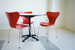 © Tetra Images - Empty table and red chair in cafeteria