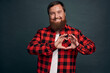 Care, love and relationship concept. Charming lovely and tender bearded boyfriend express his feelings and affection, congratulate girlfriend valentines day, showing heart gesture and smiling