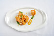 wok fried seafood prawn in pumpkin salted egg yolk sauce in white background asian halal menu