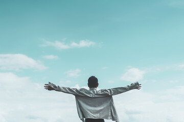 Sticker - Copy space of man rising hands on blue sky white clouds abstract background. Freedom feel good and travel adventure concept.