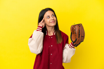 Young caucasian woman playing baseball isolated on yellow background having doubts and thinking