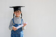 © FAMILY STOCK - Happy Asian school kid graduate in graduation cap