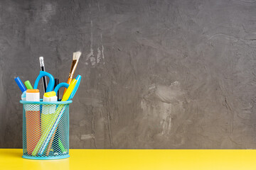 back to school concept. office stationery on table over concrete wall. workplace template