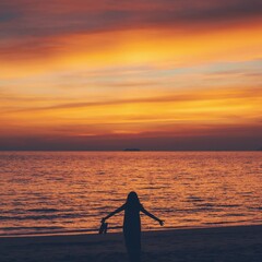 Wall Mural - Asian woman standing on the beach by the sea at morning sky with sunrise background.