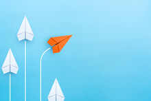 Business Concept For New Ideas Creativity And Innovative Solution, Group Of White Paper Plane In One Direction And One Orange Paper Plane Pointing In Different Way, Copy Space