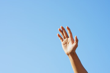 People raising hand, sky background