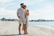 summer holidays and people concept - happy couple on beach in tallinn, estonia