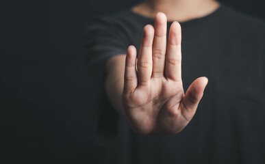 Human hand show stop sign, Hold arm one person stop gesture in dark tone.