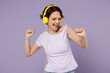 Young fun smiling joyful cool happy woman 20s with bob haircut wear white t-shirt yellow headphones listen to music in leisure time dancing isolated on pastel purple color background studio portrait