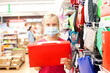 © DariaTrofimova - Teenage girl in mask  choosing stationery for school in   store