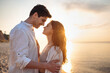 © ViDi Studio - Side view charming happy young couple two friends family man woman 20s wearing white clothes hug going to kiss together at sunrise over sea beach ocean outdoor seaside in summer day sunset evening
