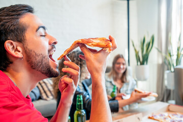 Wall Mural - Friends eating pizza and drinking beer together.