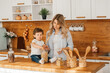 © yana_novak22 - preparation of a family breakfast. mother and child son cut bread and eat cookies with milk in morning