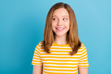 Sticker - Portrait of adorable positive schoolkid look interested empty space toothy smile isolated on blue color background