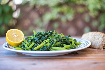 Sticker - Amaranthus blitum . Vlita Salad on a plate, on a wooden old table