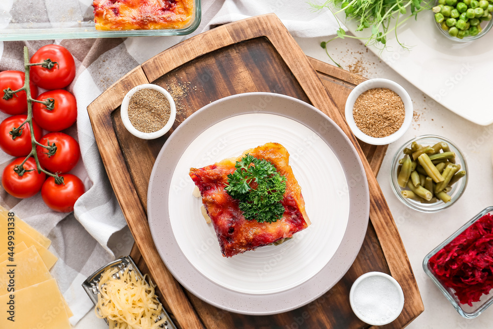 Composition with tasty vegetable lasagna and spices on light background