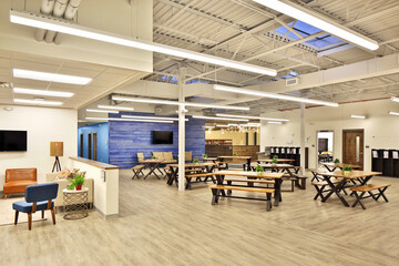 Interior of school business cafeteria seating room with benches and tables