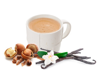 Cup of tasty cappuccino with hazelnuts and vanilla on white background