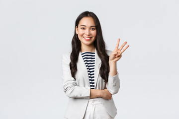 Wall Mural - Business, finance and employment, female successful entrepreneurs concept. Successful female businesswoman, asian real estate broker pointing finger, showing number three and smiling