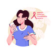 Young woman palpates her breasts, looking at the phone - breast cancer self-diagnosis. Breast Cancer Awareness Month.