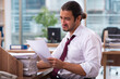 © Elnur - Young male employee and too many work in the office