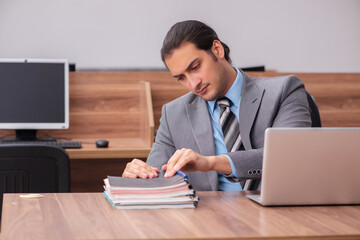 Young male employee working in the office