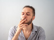 © Alexandre - Caucasian Man in Gray Shirt Smokes a Cigarette in White Room in Medellin, Colombia