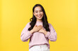 People emotions, lifestyle and fashion concept. Grateful cute asian girl in casual outfit thanking for praises, feel touched and delighted, smiling appreciate nice gesture, standing yellow background