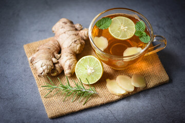 Hot ginger juice in glass and mint with slices ginger root herbal juice tea rosemary, Ginger and lemon fresh cocktail