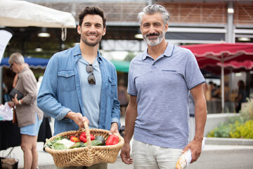 Wall Mural - friends with baskets of produce at farmers market