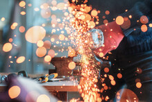 Worker Working With A Circular Grinder On A Metal With Sparks Flying Out Of Them, Selective Focus