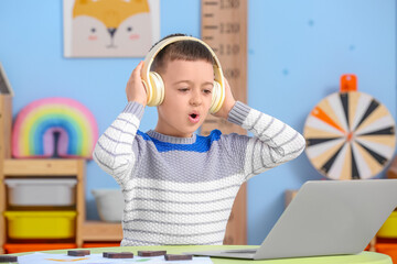 Wall Mural - Little boy with laptop training pronounce letters at home