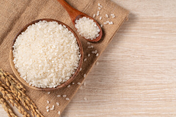 Wall Mural - White rice in a bowl on wooden table background.