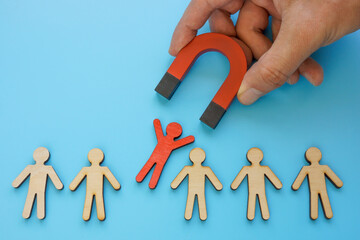 talent employee attracting and recruitment. red figure and magnet.