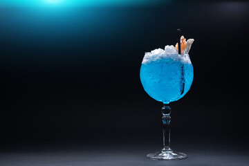 Wall Mural - luxury blue alcohol cocktail decorated with shrimp in glass on black background
