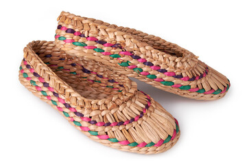 Wall Mural - Souvenir bast shoes, woven from a vine on a white background. Ethnic shoes