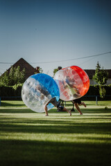 Zorbing bumper football soccer on a green field