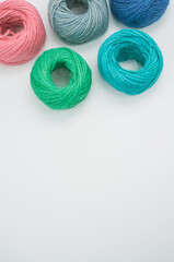 Canvas Print - Vertical shot of colored cotton threads on a white background