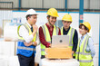 © offsuperphoto - factory workers meeting and using laptop computer for work in warehouse storage