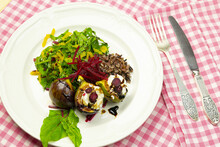 Fig Salad With Goat Cheese And Beets On A White Plate On A Checkered Tablecloth