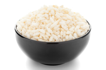 Close-up of organic  puffed / roasted rice (kheel or murmura)  in a black ceramic bowl over white background.