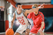 © zinkevych - Two young men playing basketball and feeling excited
